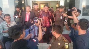 PH pakai dasi mendampingi kliennya menuju mobil tahanan di pintu utama  kantor kejati kepri. Foto prokepri